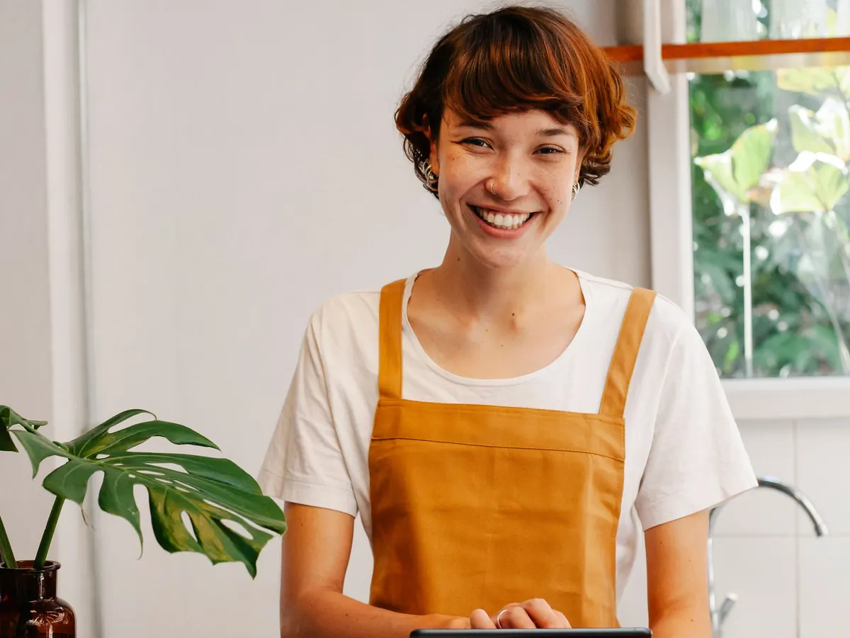 A business owner using a phone at the counter