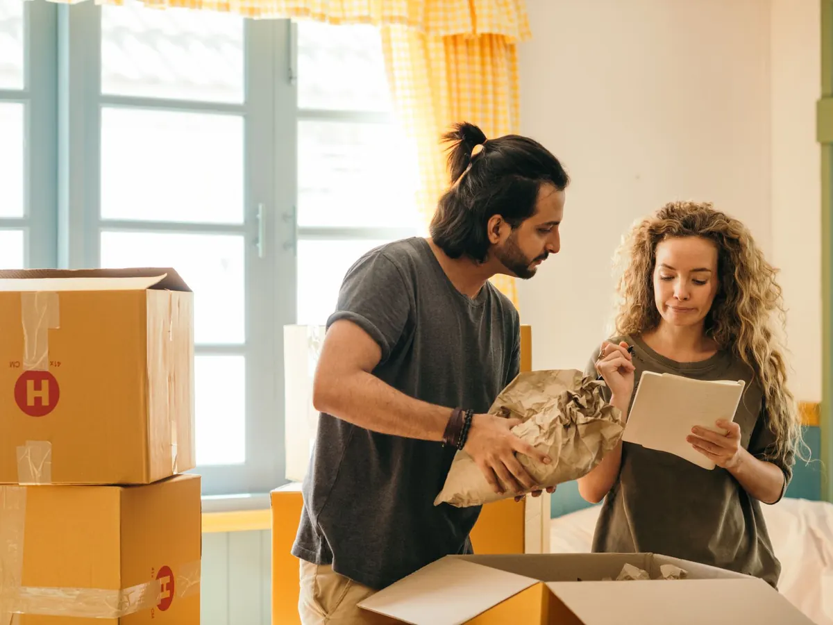 A couple unpacking boxes in their new home